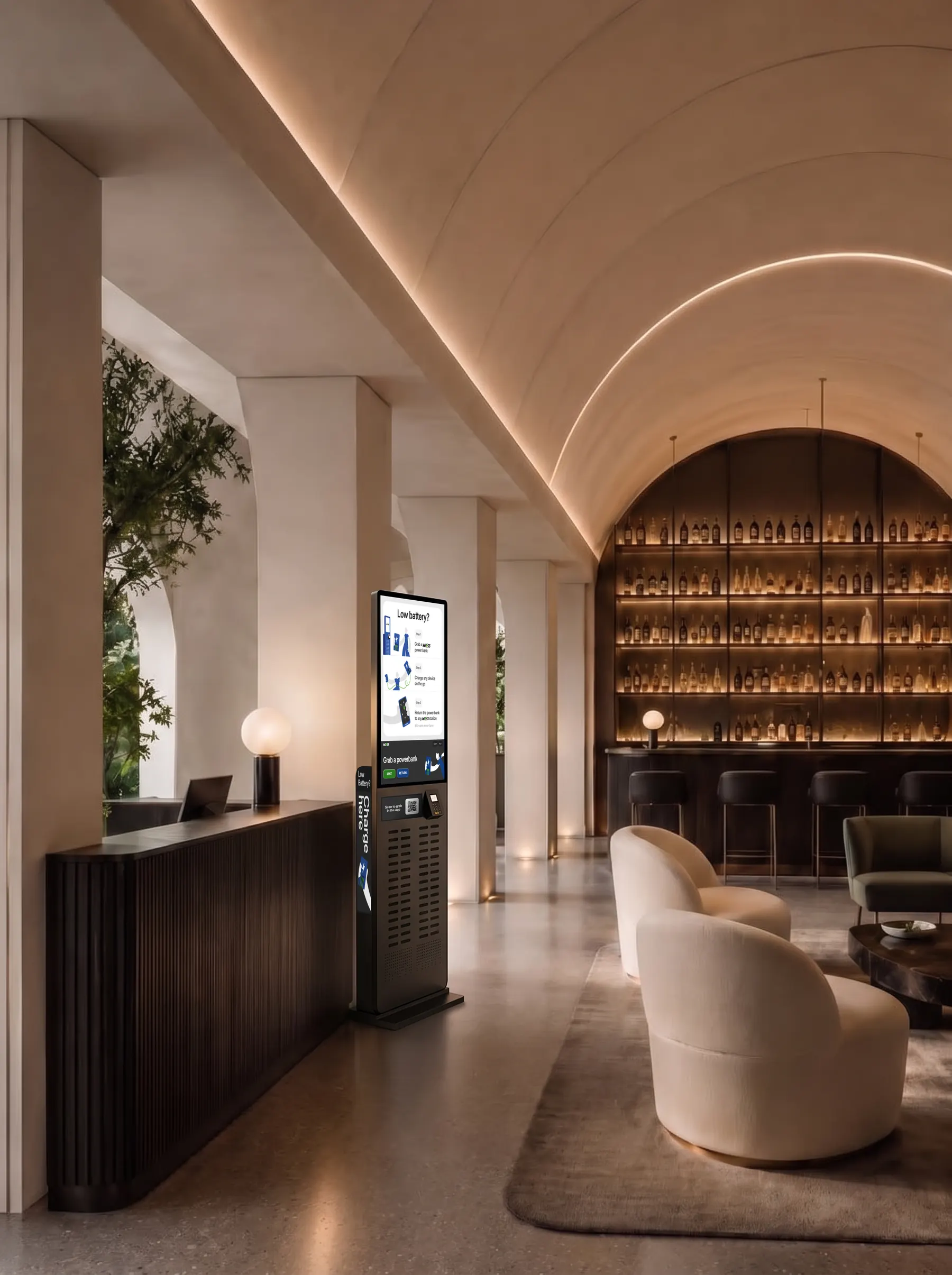 A tall we53 charging station next to the reception desk of an evening hotel lounge bar.